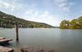 Long exposure of Windermere, white boats, mountains and trees in Belle Isle with wodden post in foreground from Far Sawrey, Lake