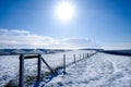 A long fence on the top of a white snow covered mountain Royalty Free Stock Photo
