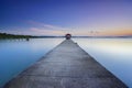 Long fisherman jetty heading to the sea with soft pastel sunset Royalty Free Stock Photo