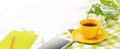 Long Flat lay banner phone, yellow cup of tea and flowers on white blanket with green napkin