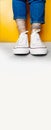 Long format banner, women legs in white clean new sneakers, transparent thin socks with silver shiny stars and blue jeans on