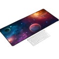 Long gaming mousepad with colorful nebula and planets next to keyboard computer desk Royalty Free Stock Photo