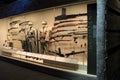Long glass case with exhibit of weapons and soldier`s uniforms, WWII Museum, New Orleans, 2016
