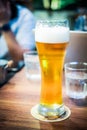 Long glass of fresh light beer with foam Royalty Free Stock Photo