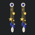 Long gold dangle earrings with sapphire, diamond and pearl isolated on dark background. Modern Trendy Expensive Women Accessories Royalty Free Stock Photo