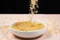 Long grain parboiled basmati rice pouring into the plate Royalty Free Stock Photo