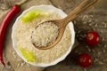 Long grain rice in a wooden spoon on a background plates, chili pepper, cherry tomato. Healthy eating, diet Royalty Free Stock Photo