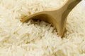 Long grain rice with a wooden spoon