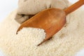 Long grained rice, wooden scoop and burlap bag