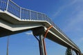 Long gray concrete footbridge with iron handrails
