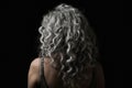 Long Gray Curly Hair , Rear View On Black Background. Generative AI