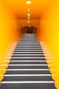 Long gray stairs with many steps and yellow wall Royalty Free Stock Photo
