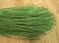 Long green plastic twigs of a broom.
