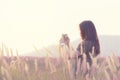 Long hair asian happy lady use smart mobile phone take photo of view standing in cosmos field in vintage picture style Royalty Free Stock Photo
