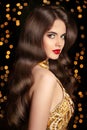 Long hair. Brunette girl with shiny wavy hairstyle and red lips Royalty Free Stock Photo