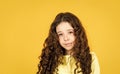 Long hair. Easy hairdo. Beauty supplies. Perfectly untangle curly hair. Pretty girl curly hair yellow background