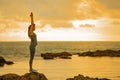 Long hair, good shape Asian woman playing yoga, exercise on rock Royalty Free Stock Photo