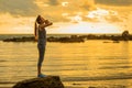 Long hair, good shape Asian woman playing yoga, exercise on rock Royalty Free Stock Photo