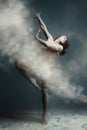 Long hair muscle man dancer in dust Royalty Free Stock Photo