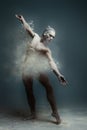 Long hair muscle man dancer in dust Royalty Free Stock Photo