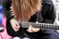 Long hair rock guitarist playing electric guitar Royalty Free Stock Photo