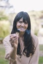 Long hair woman holding a burning palo santo or holy sacred tree stick