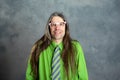 Long haired, angry man in green shirt pink glasses Royalty Free Stock Photo