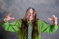 Long haired, angry man in green shirt pink glasses Royalty Free Stock Photo