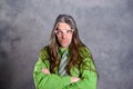 Long haired, angry man in green shirt pink glasses Royalty Free Stock Photo