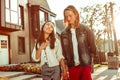 Long-haired Asian girl being excited with compliments of blonde guy