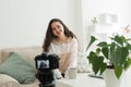 A beautiful woman is recording a video for a blog. Technology and blogging concept Royalty Free Stock Photo