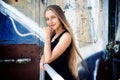 Long-haired girl near graffiti wall