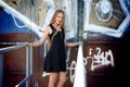 Long-haired girl near graffiti wall