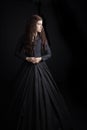 Long-haired, brunette Victorian woman in a black ensemble Royalty Free Stock Photo