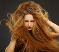Long-haired curly redhead woman Royalty Free Stock Photo