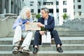 Long-haired elderly hippy man telling fired man he is not alone