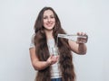 Long-haired girl pours water from a bottle into glass Royalty Free Stock Photo