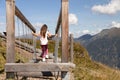 Long-haired girl walking on movable logs on playground in mountains, Austria, Alps Royalty Free Stock Photo