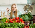 Long-haired housewife cooking with fresh vegetables Royalty Free Stock Photo