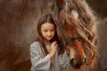 Little girl with palomino miniature horse in summer day