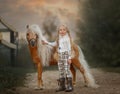 Little girl with palomino miniature horse in summer day