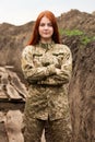 Long-haired red-haired girl in the military uniform of the armed forces of Ukraine Royalty Free Stock Photo