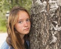 Long haired teen girl in the Park closeup portrait near a tree. Nature. Royalty Free Stock Photo