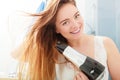 Long haired woman drying hair in bathroom Royalty Free Stock Photo