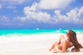 Long haired woman with flower in hair in bikini at tropical beach Royalty Free Stock Photo