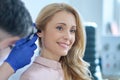 Long-haired woman and otolaryngologist examining ear Royalty Free Stock Photo