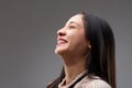 Long-haired woman restrains joy, looks upward