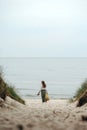 Long-haired woman with woven bag going to beach Royalty Free Stock Photo