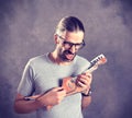 Long haired young man with cardboard guitar Royalty Free Stock Photo