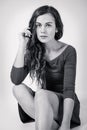 Long-haired young woman sitting on the floor